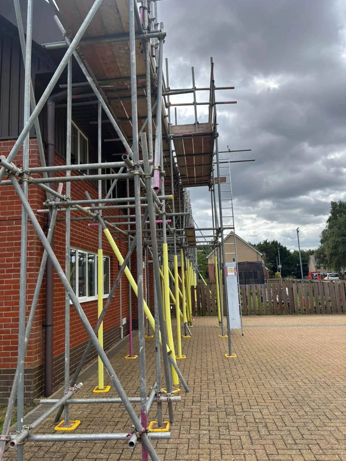 Scaffold with yellow pedestrian protection along school walkway, Acorn Park