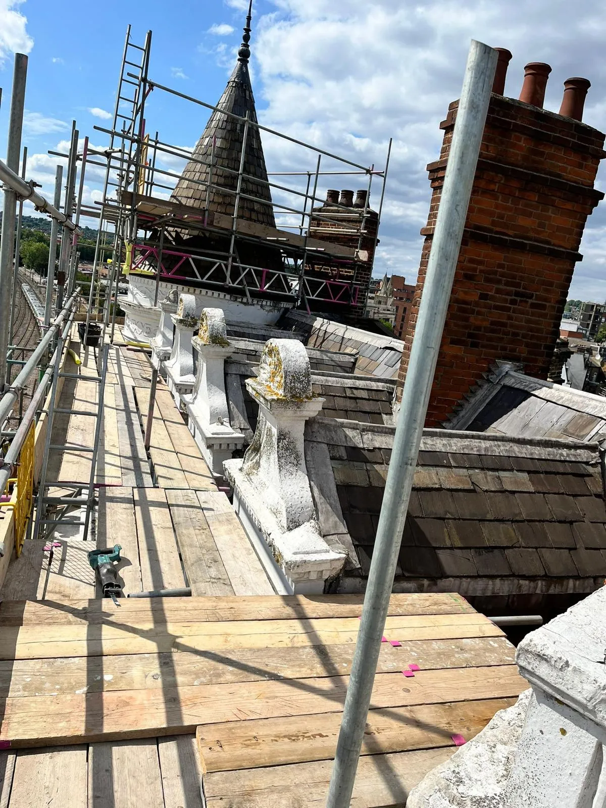 Scaffold platform at roof level with turret and chimneys, Assembly House