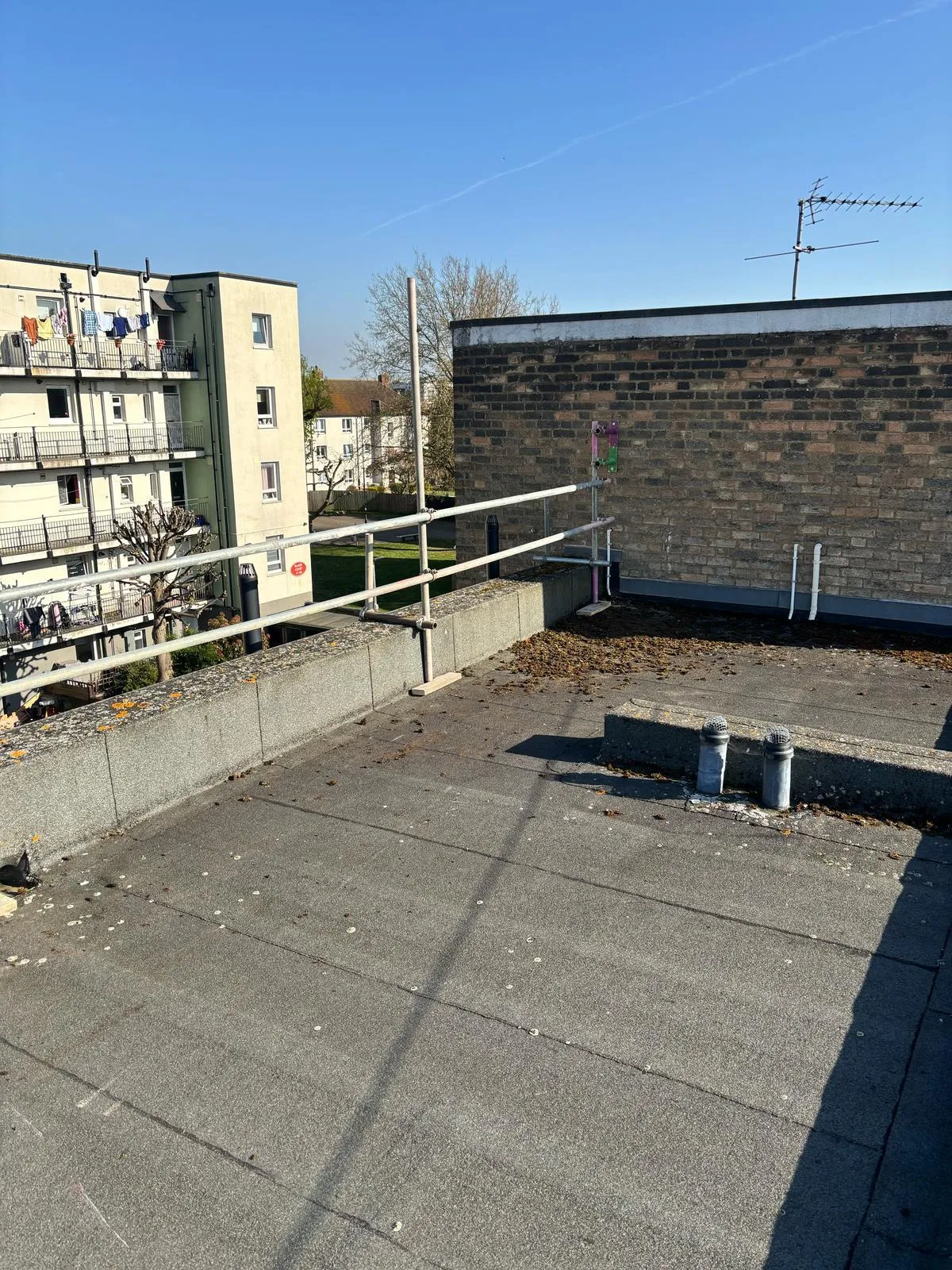 Flat roof edge protection guardrail scaffold on residential block, Blaker Court