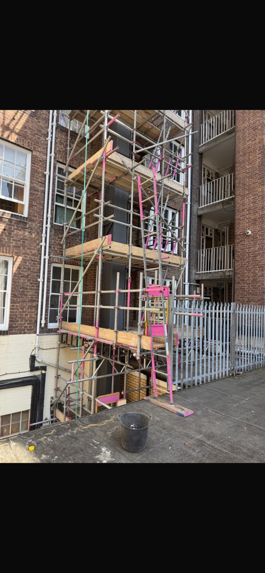 Boarded working lifts and ladder access on confined scaffold at Queensway, London - Pinnacle Scaffolding