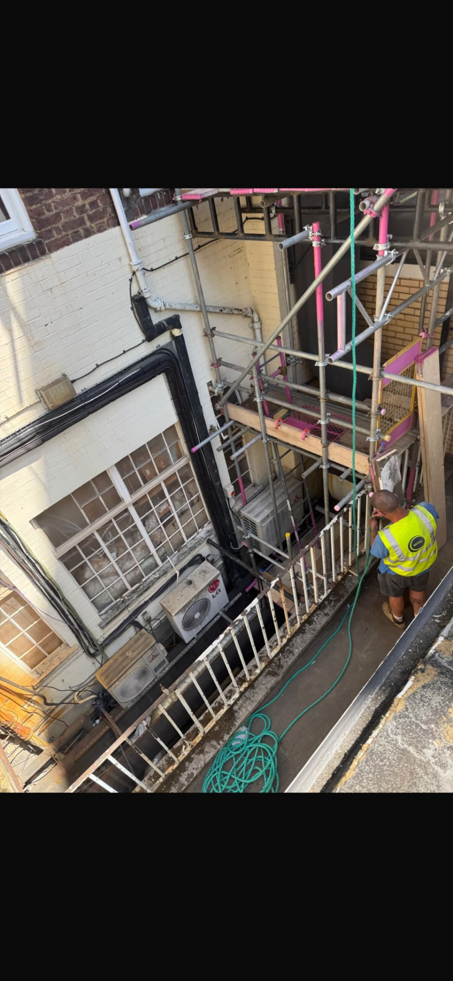 Scaffold set out around live air conditioning plant in a confined lightwell at Queensway, London - Pinnacle Scaffolding
