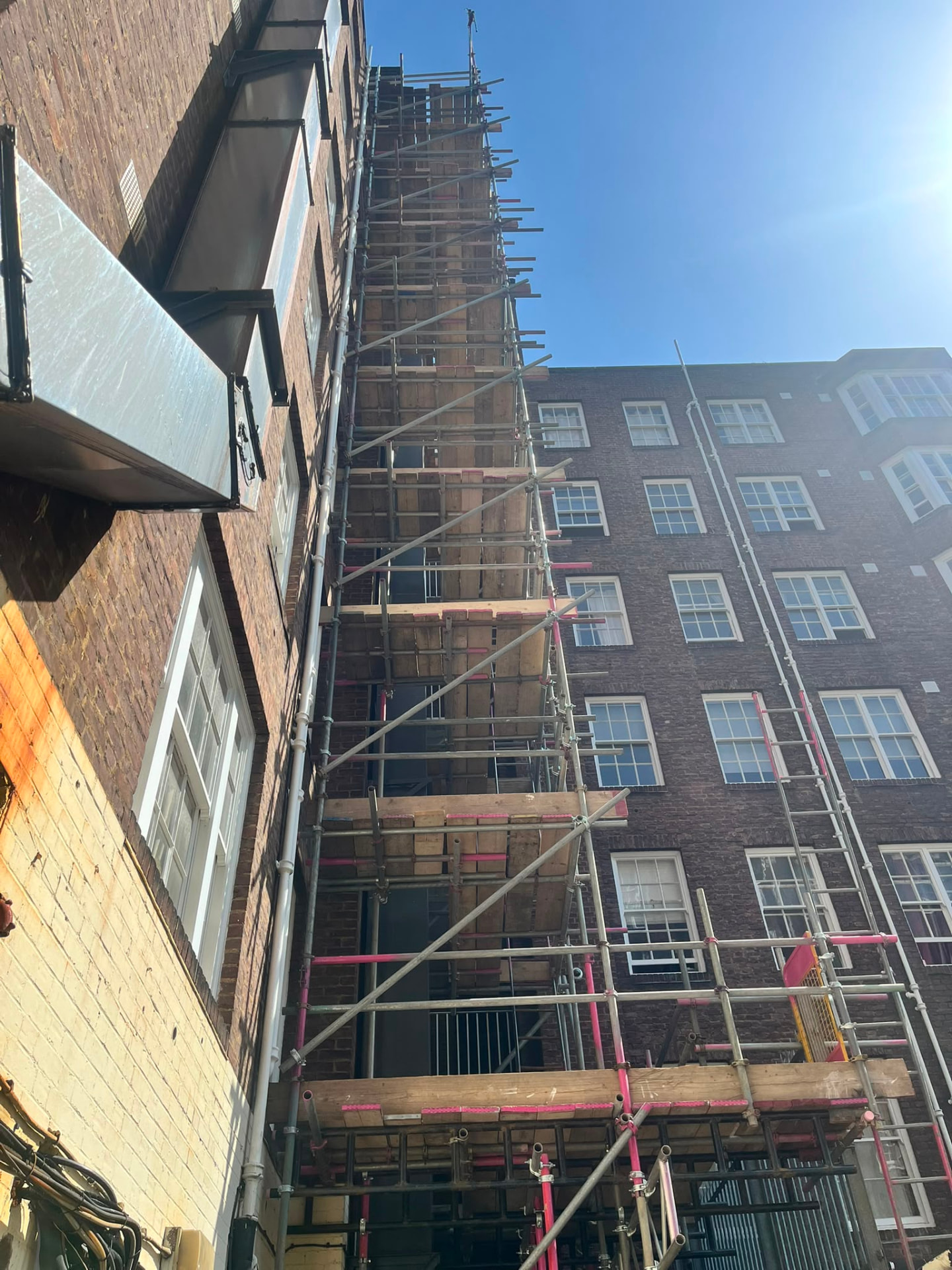 Full height scaffold in a confined rear lightwell at Queensway, London W2, for ducting installation - Pinnacle Scaffolding