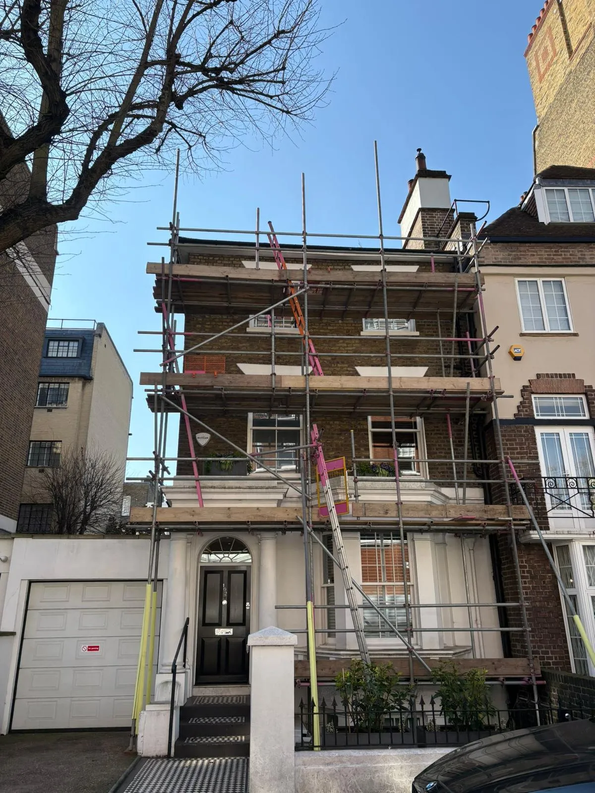 Full facade scaffold on period townhouse for exterior decoration, East London