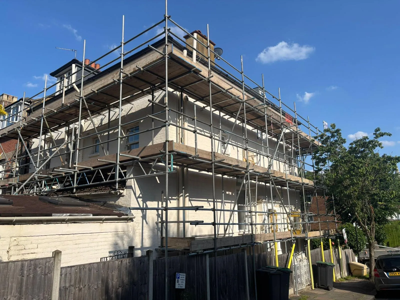 Corner wrap scaffold on residential property for painting programme, housing association