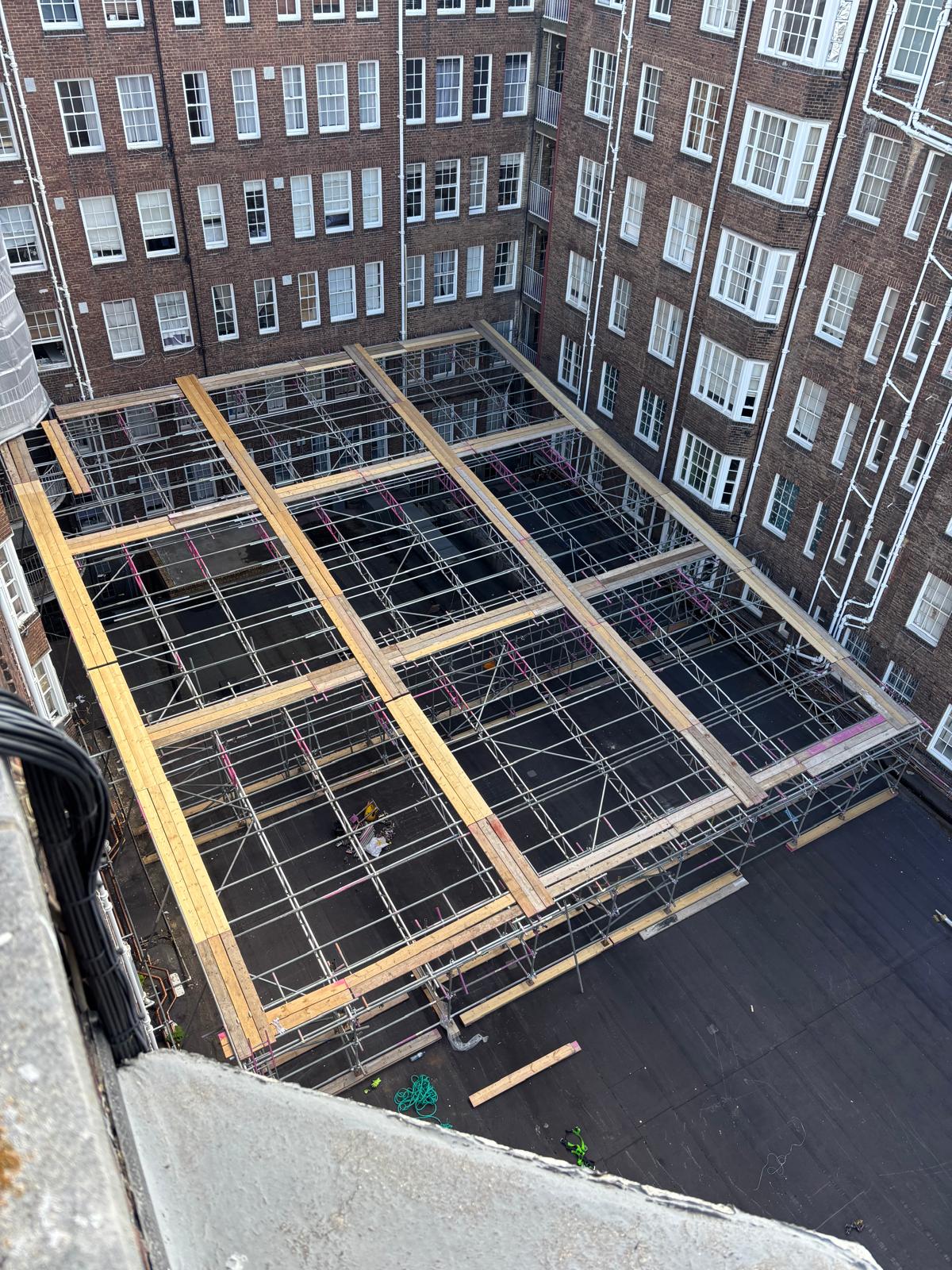 Clear span enclosed roof scaffold across the full courtyard at Queensway Market, London W2 - Pinnacle Scaffolding