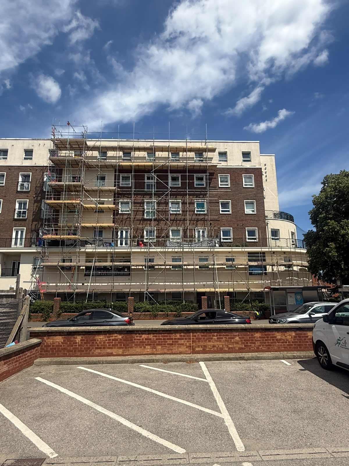 Ground level view of full height render repair scaffold on a residential block in New Malden, Kingston - Pinnacle Scaffolding