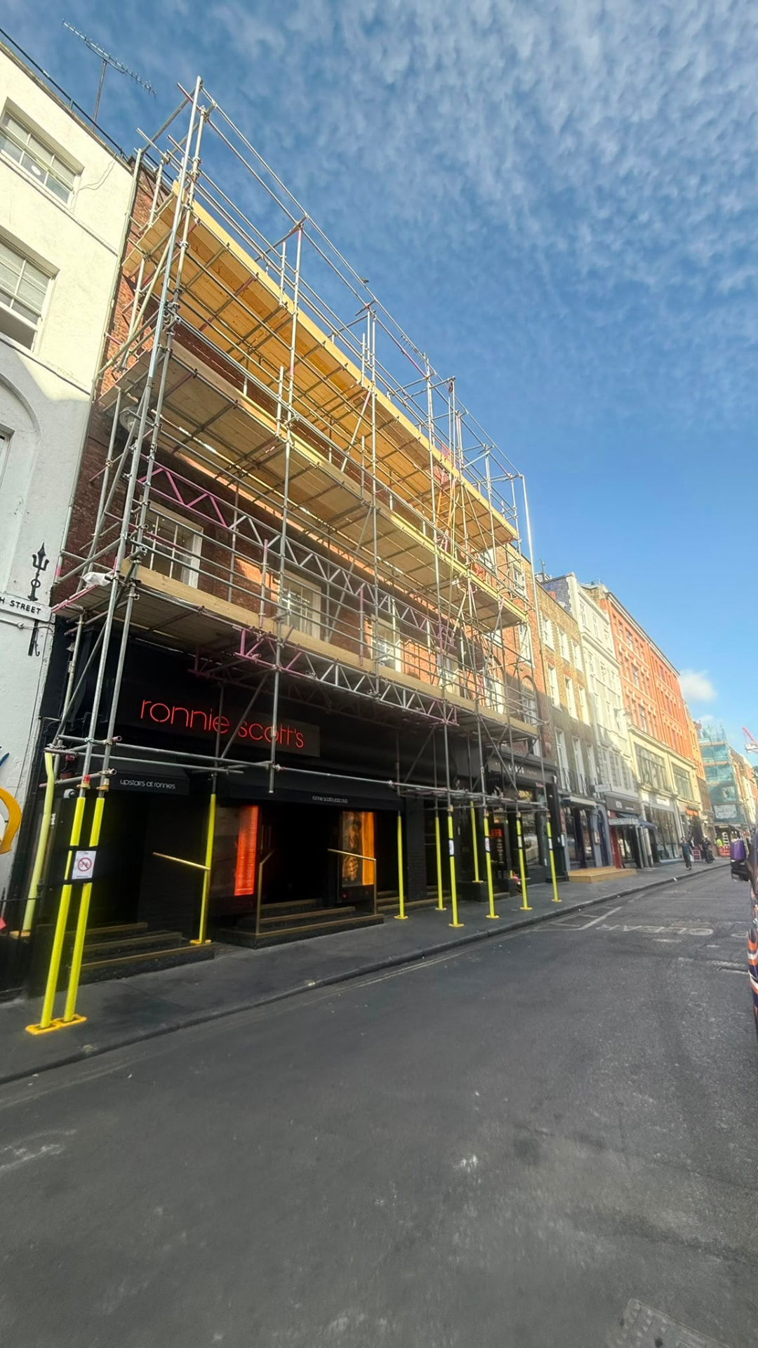 Scaffold erected across the frontage of Ronnie Scott's Jazz Club on Frith Street, Soho, before encapsulation - Pinnacle Scaffolding