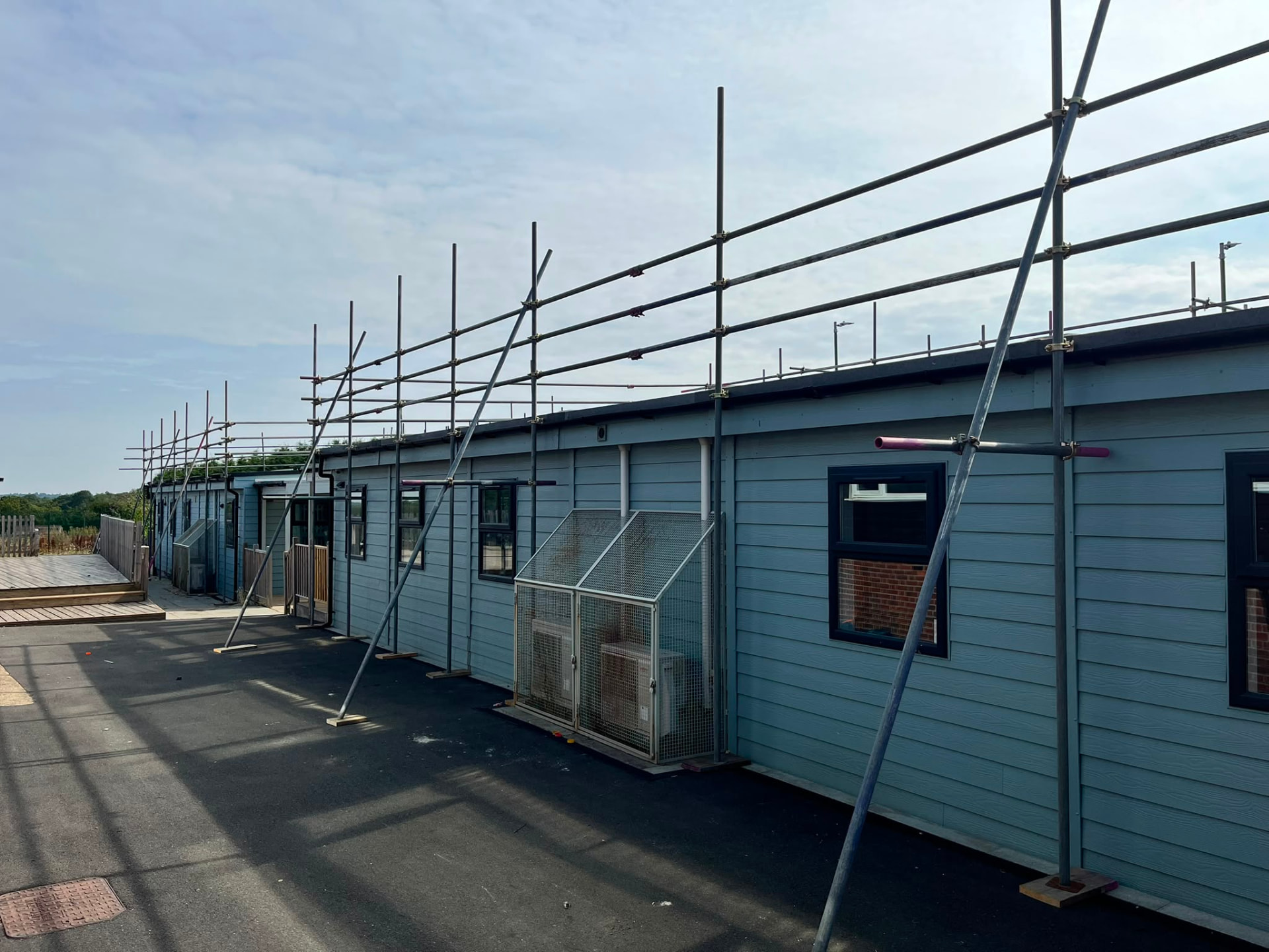 Scaffold edge protection with raking braces to timber sole boards on a Bromley solar installation site - Pinnacle Scaffolding